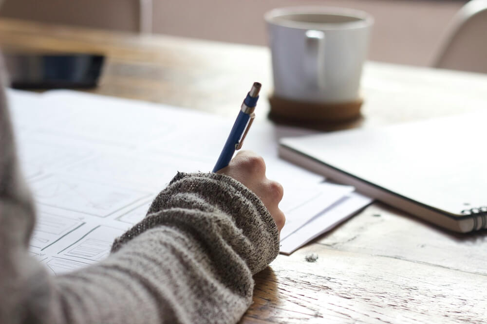 person doing paperwork on a table